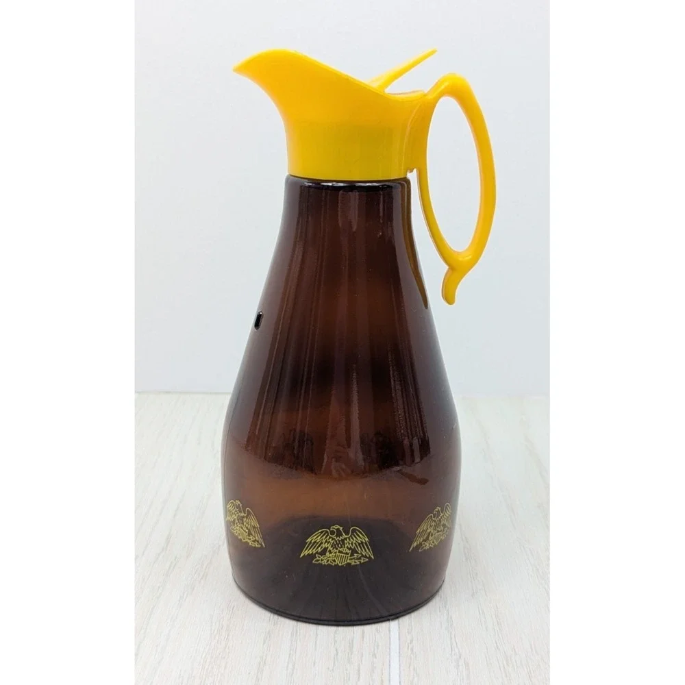 Log Cabin vintage syrup dispenser pitcher amber glass yellow lid patriotic eagle